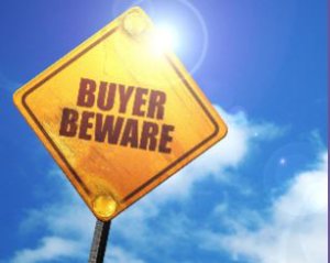 Buyer Beware Sign against blue sky background